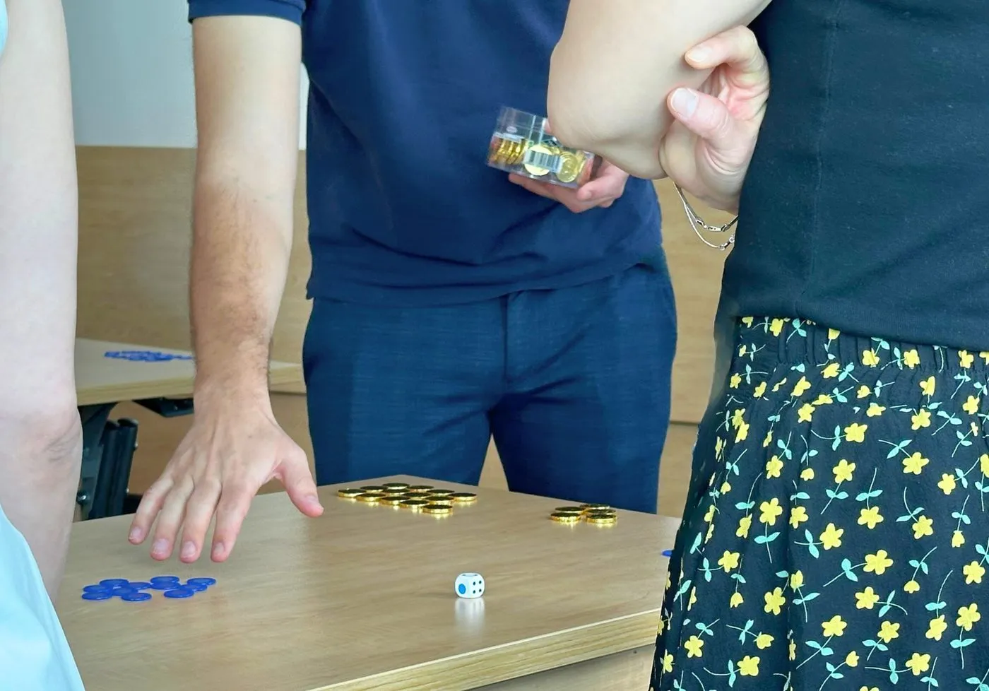 Beer-game supply-chain simulation with coins at an Opaix training